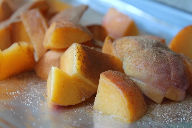 Fresh peaches on a sheet pan.