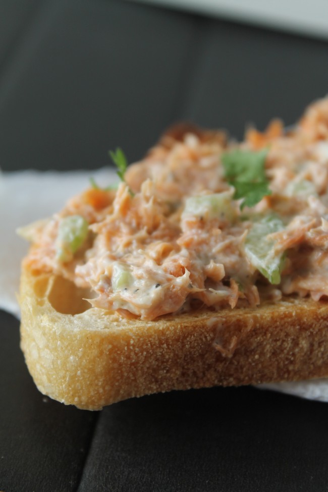 Smoked salmon dip spread over a piece of toast.