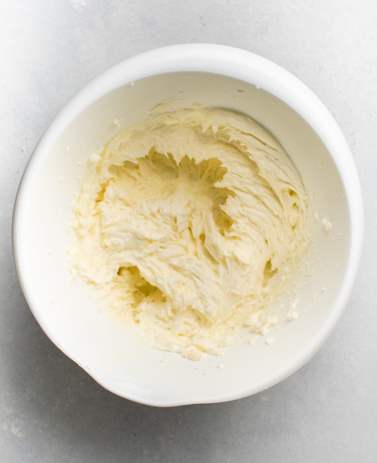 Lemon vanilla buttercream in a white mixing bowl.