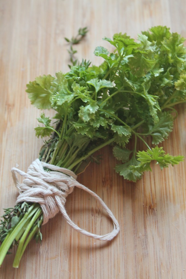 Fresh herbs tied into a bundle with kitchen twine.