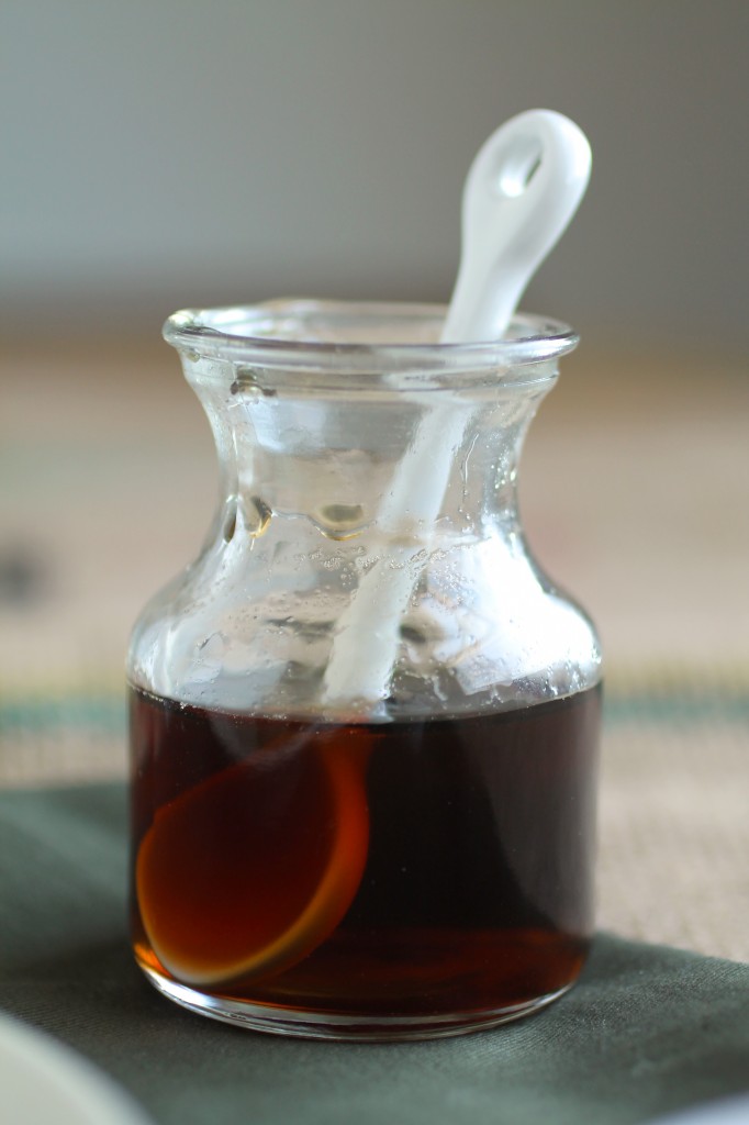 Small glass jar filled with maple syrup.
