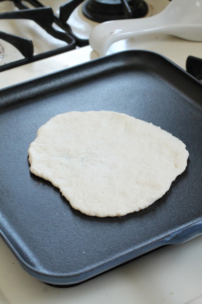 Raw tortilla dough on a large skillet.
