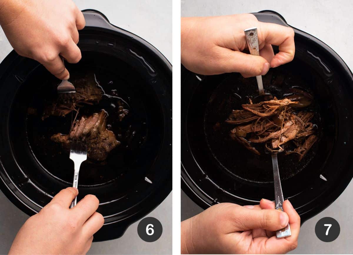 Using two forks to shred beef in the bowl of a slow cooker.