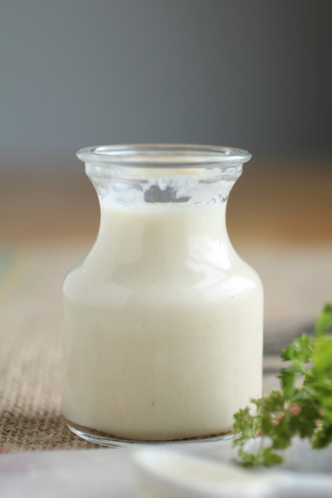 White alfredo sauce in a glass jar.