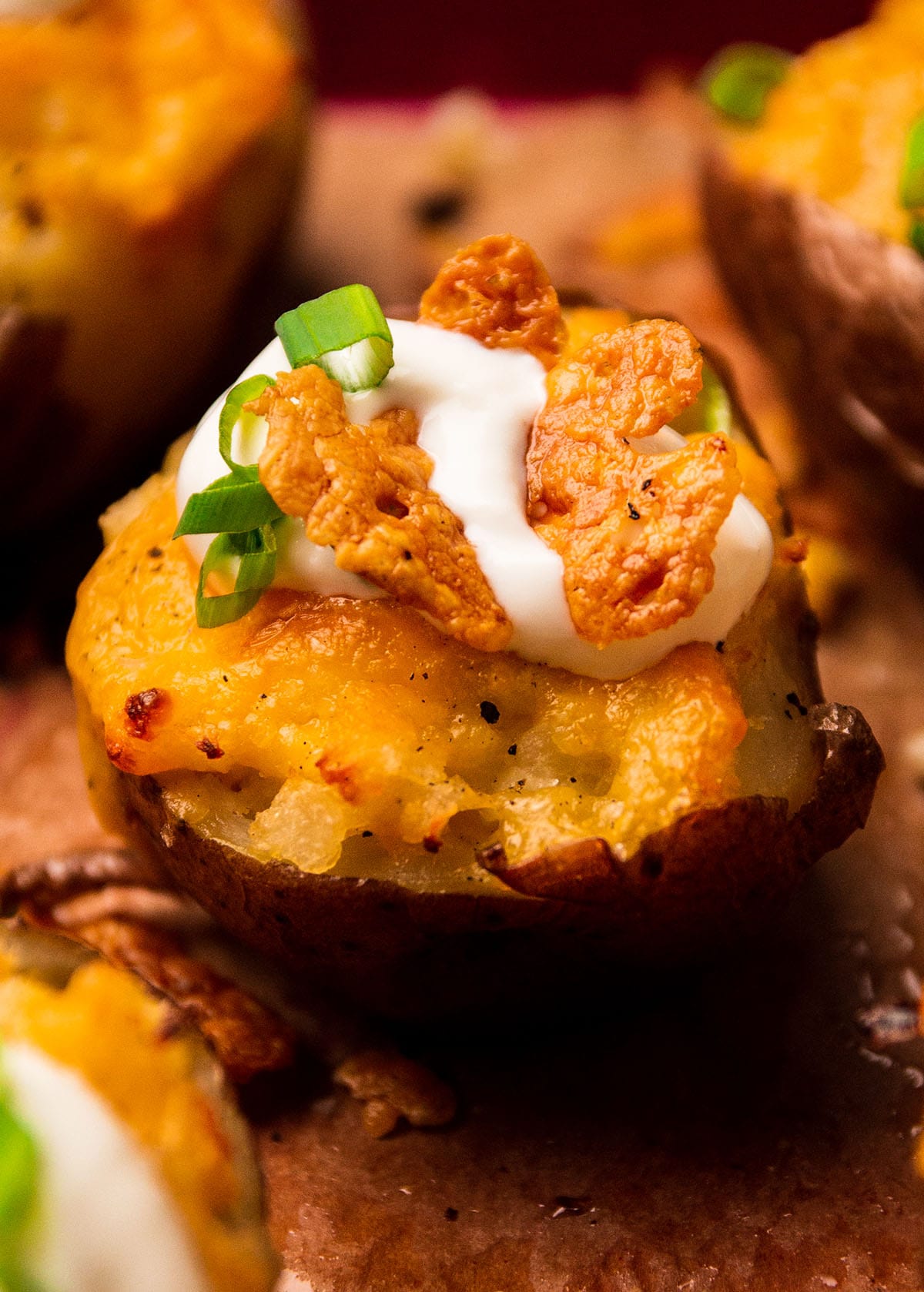 Topping twice baked potato with crispy cheese pieces.