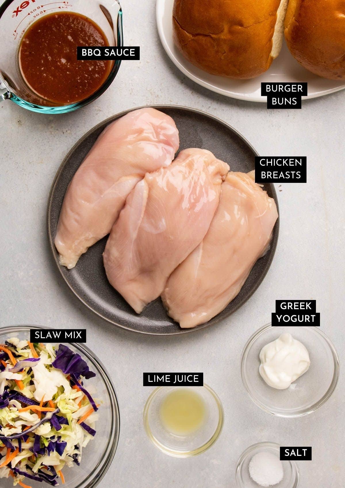 Barbecue chicken sandwich ingredients on a white table.