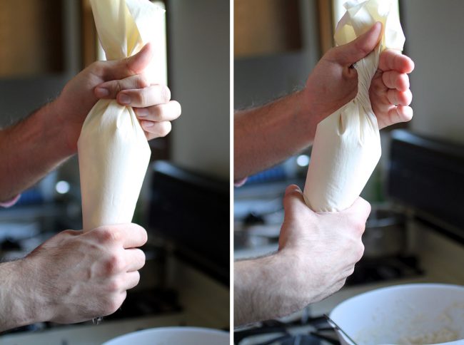 Hands twisting a white pastry bag to seal the top.