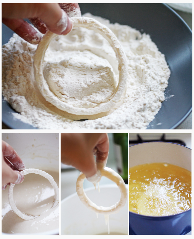 Hand dipping an onion ring into flour and batter.