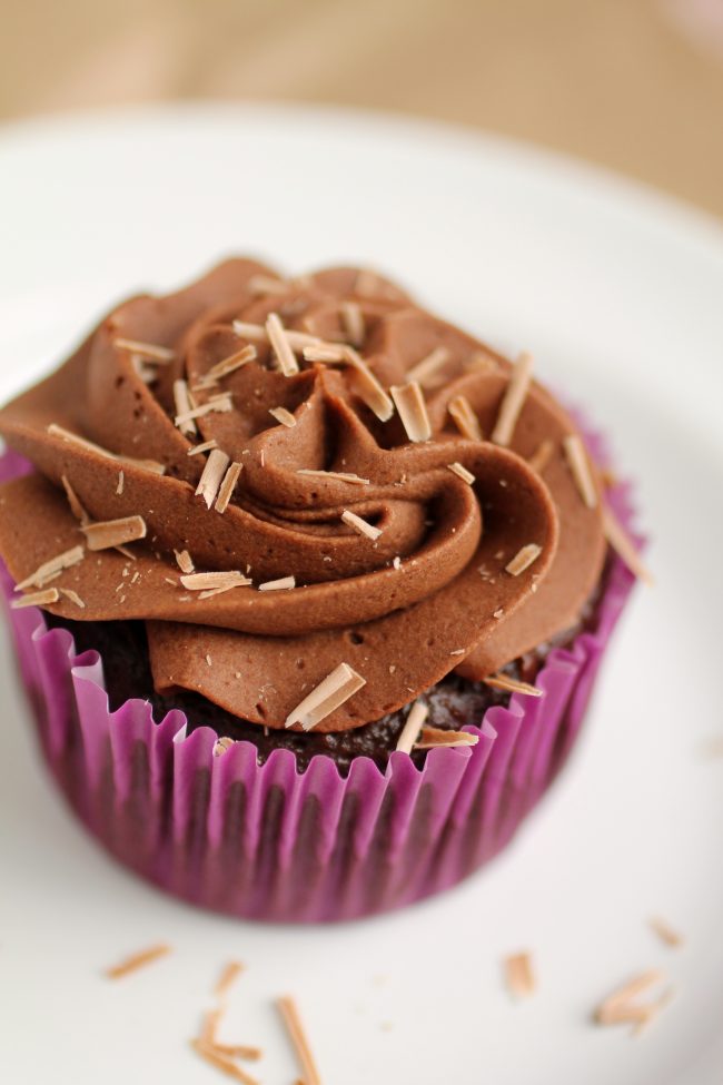 Chocolate cupcake with chocolate buttercream topped with chocolate shavings.