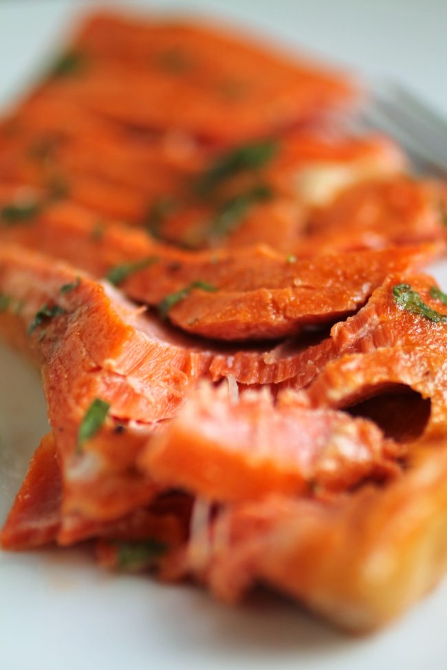 A piece of salmon, cut into flaky pieces.