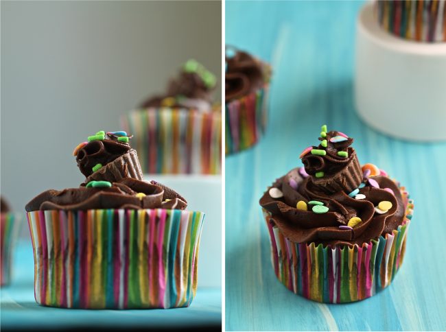 Chocolate cupcake in a rainbow wrapper, topped with a mini reese\'s cup that\'s frosted to look like a mini cupcake.