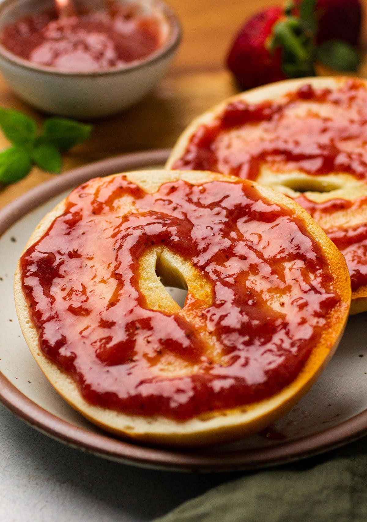 Slow cooker strawberry jam on a toasted bagel.