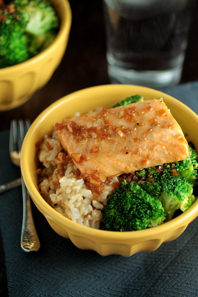 Roasted salmon in a yellow bowl with rice and broccoli.