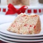 Slice of white chocolate cake with red confetti sprinkles