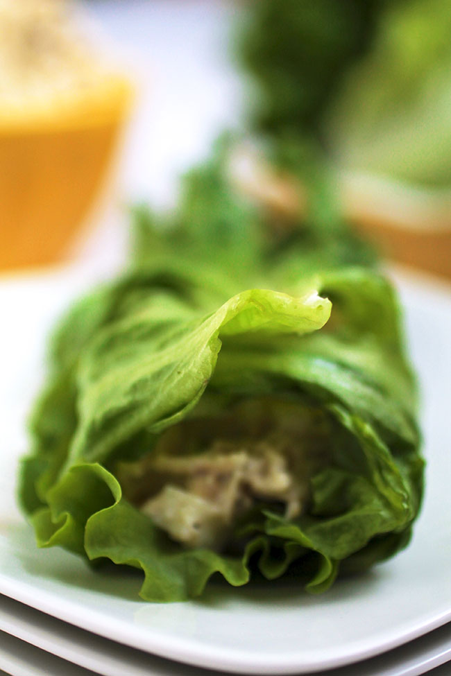 A scoop of chicken salad wrapped in a lettuce leaf.