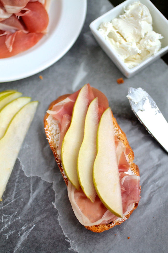 Pear slices and prosciutto on a piece of toast.