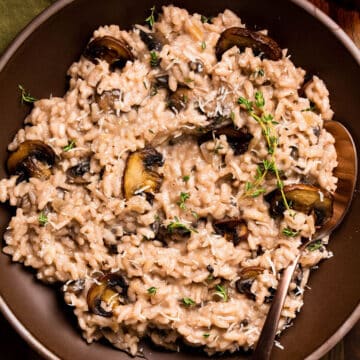 Red wine risotto topped with mushrooms and thyme.