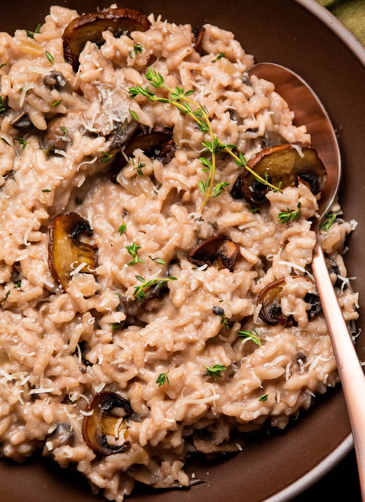 Red wine risotto topped with mushrooms and fresh thyme.