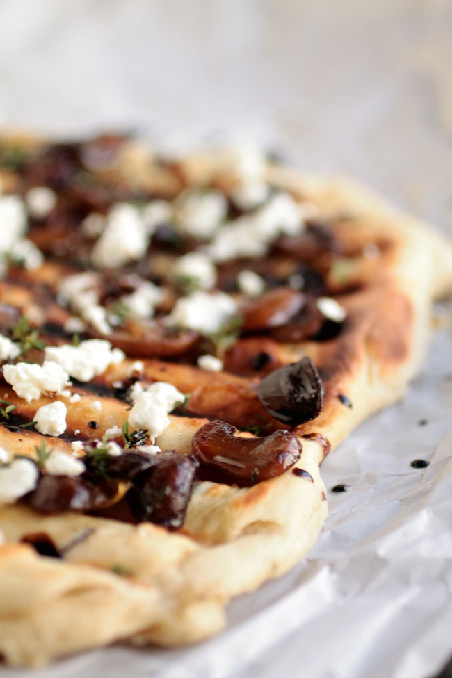 Close up of the mushrooms and crumbled goat cheese on top of the flatbread.