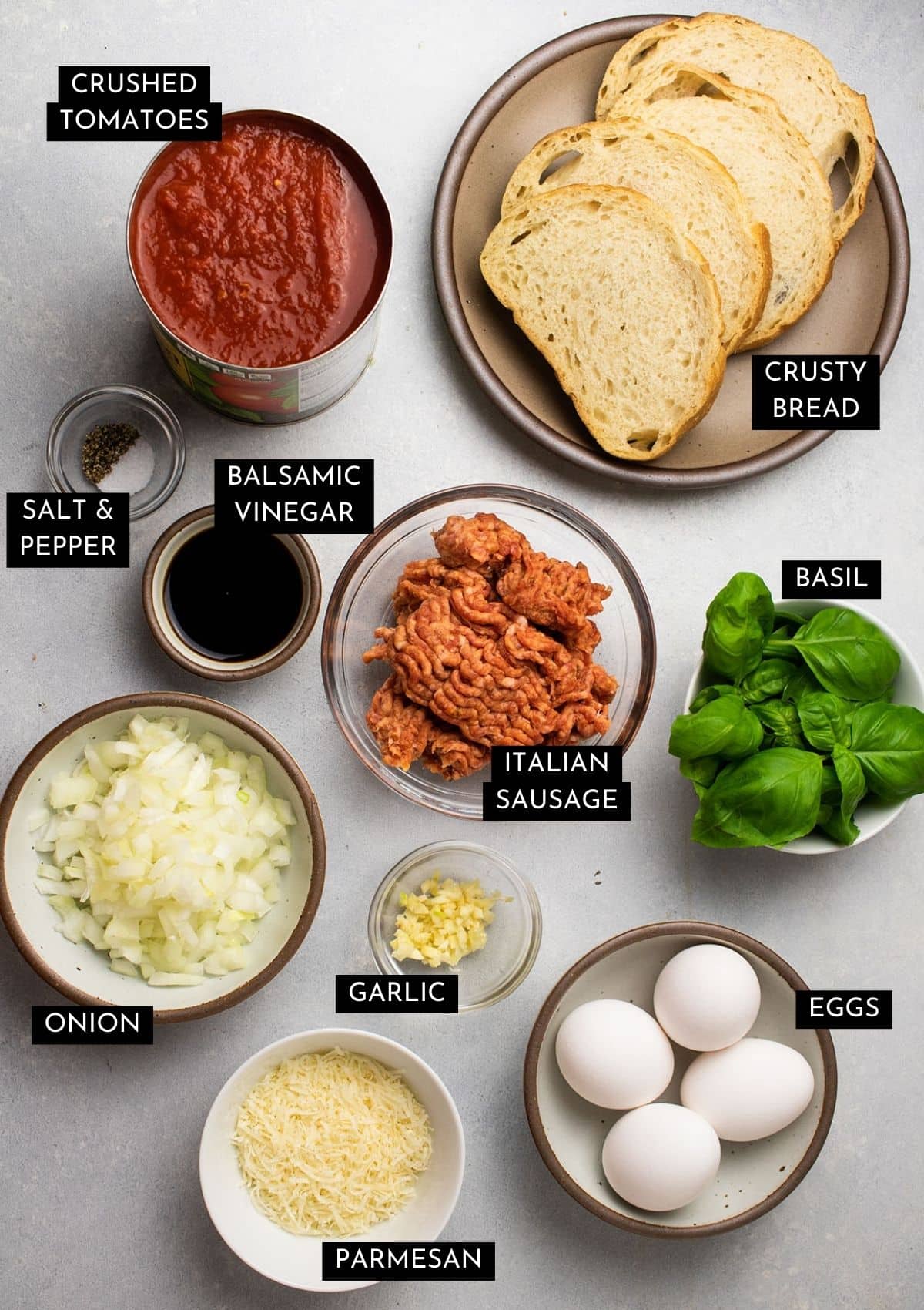 Ingredients organized into individual bowls on a white table.