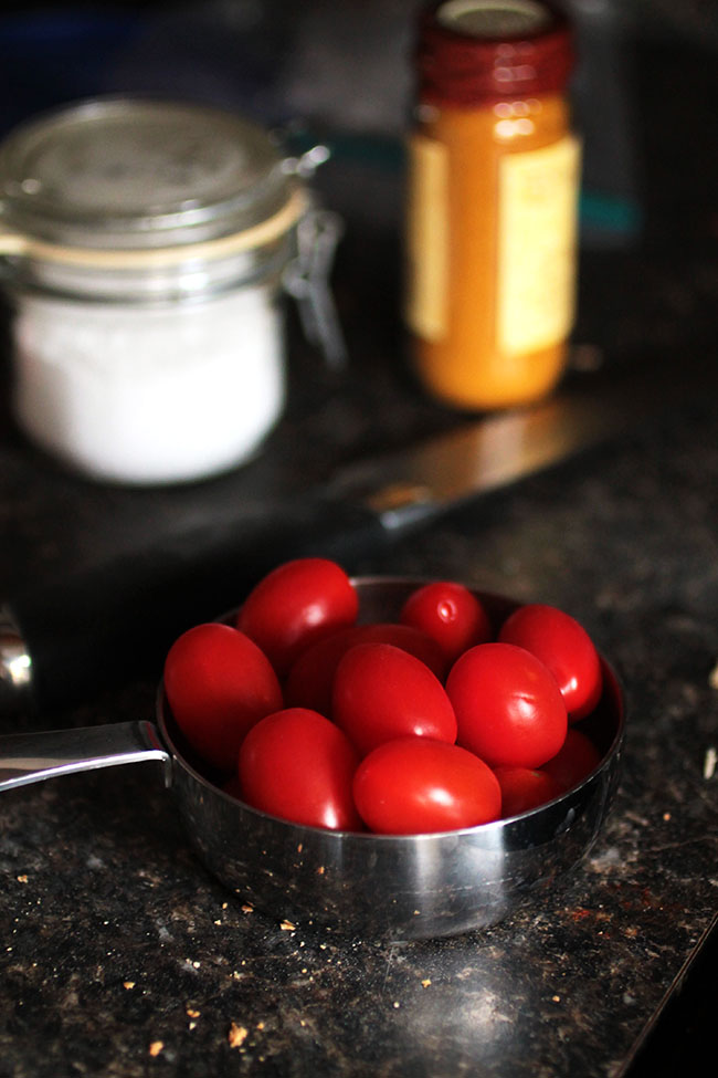 Cherry tomatoes in a measuring cup.