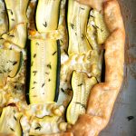 Overhead view of a zucchini galette on a baking sheet.