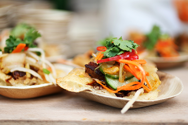 Mini tostadas topped with cilantro and pickled veggies.