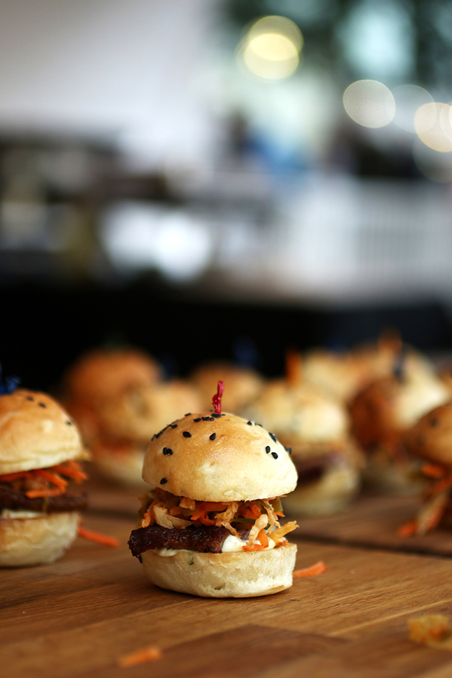 Slider sandwiches on a wooden table.