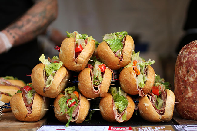 Sub sandwiches stacked in a pyramid.
