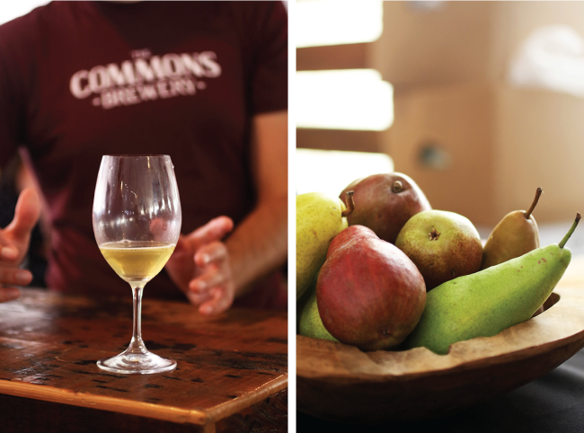 A glass of wine on a table next to a bowl of fresh pears.