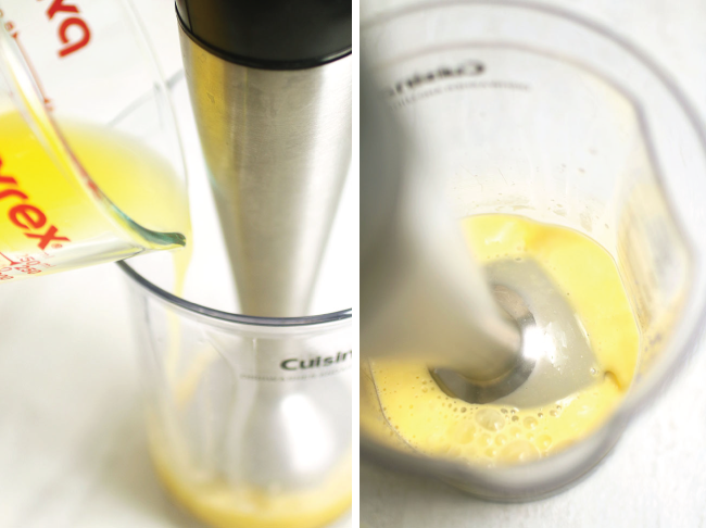 Using the immersion blender to blend hollandaise sauce in the plastic beaker.