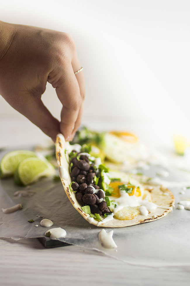 Hand folding a breakfast taco into shape.