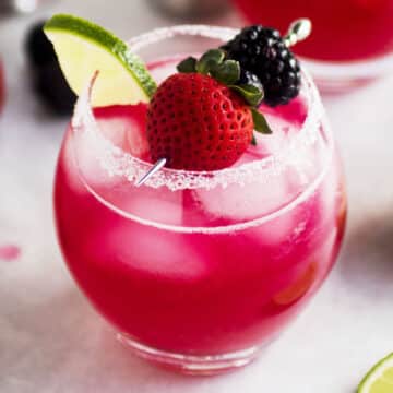 Berry margarita topped with fresh berries.