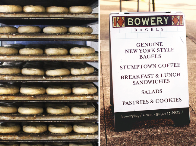 A stack of shaped bagels next to the Bowery Bagels sign.