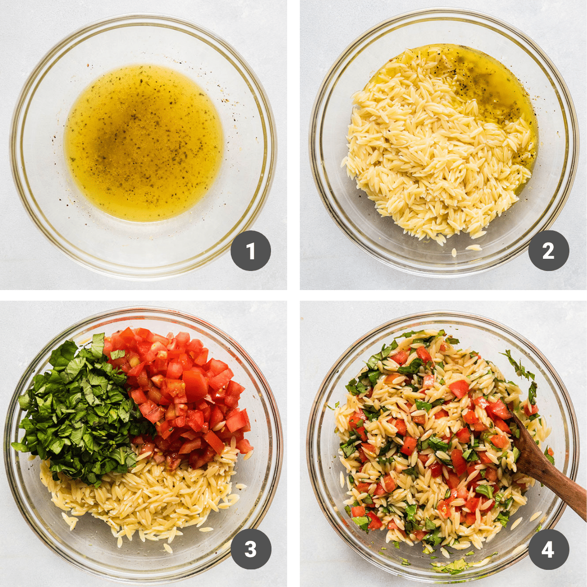 Stirring orzo salad ingredients together in a glass mixing bowl.