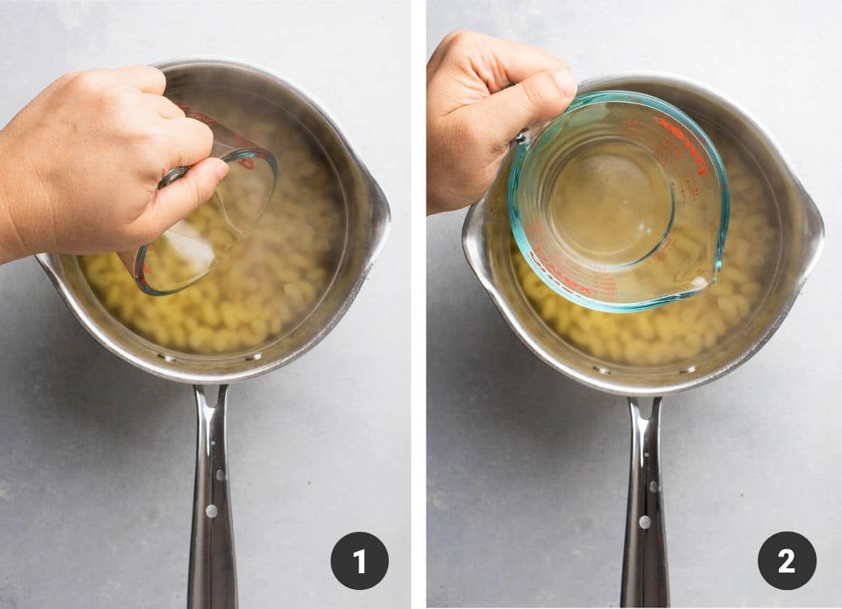 Hand using a glass measuring cup to scoop pasta water out of a pot.