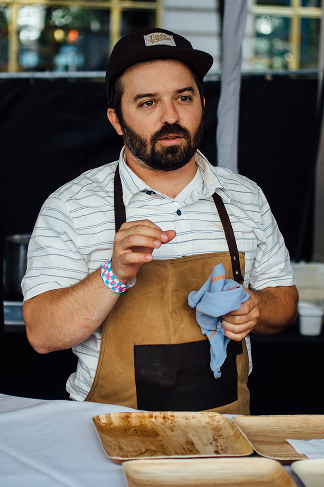 A chef describes his dish to a crowd.