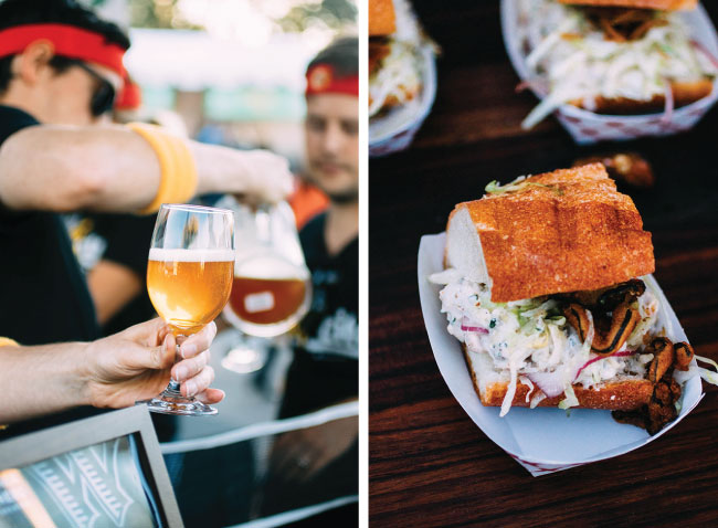 A wine glass filled with beer next to a sandwich on a white plate.