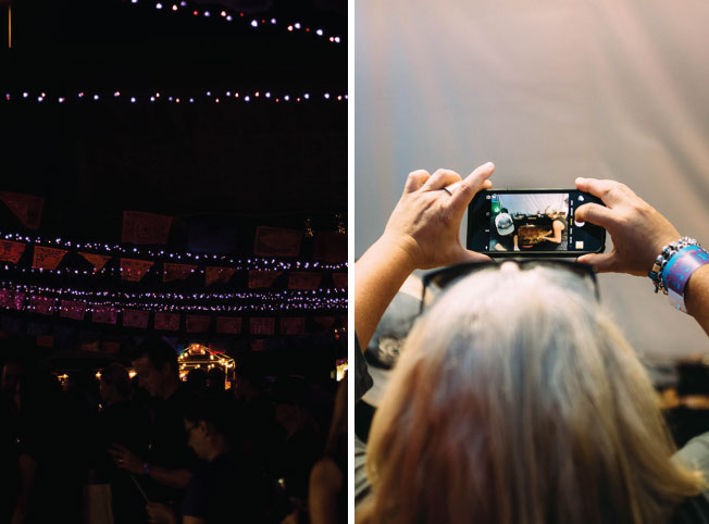 A woman takes a photo with her cell phone.