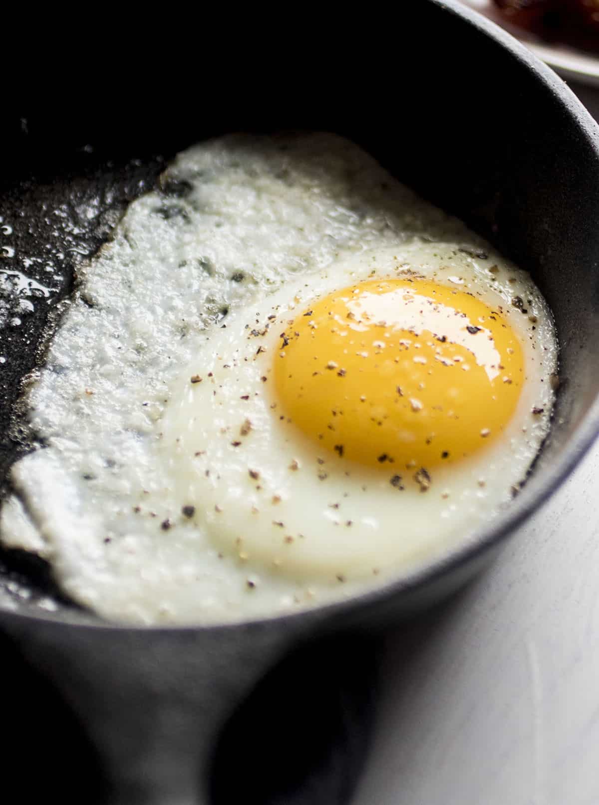 Sunny side up egg in a small cast iron skillet.
