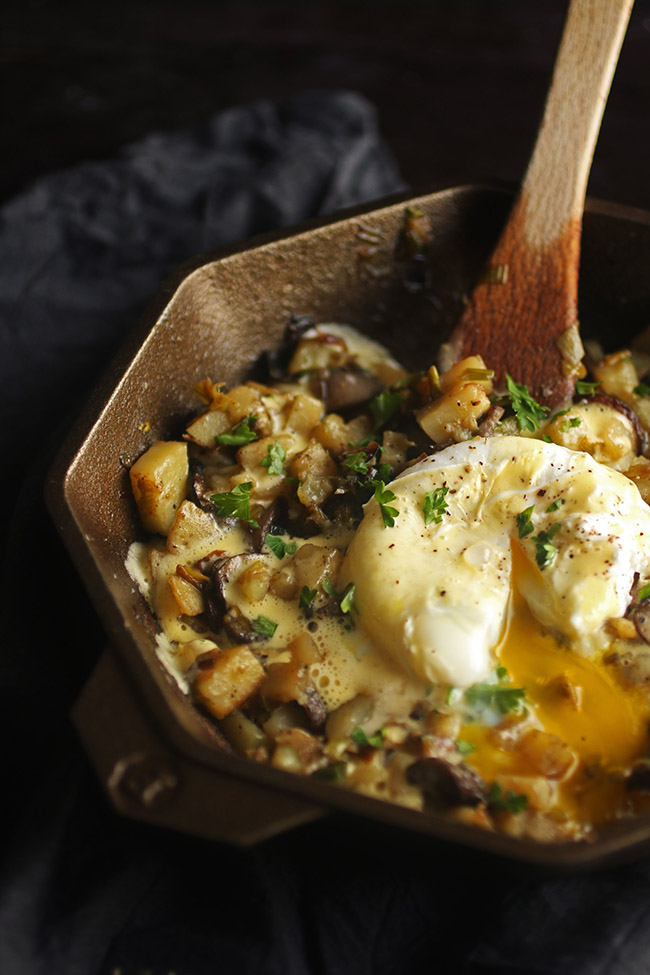 A Finex skillet filled with breakfast hash and a poached egg.