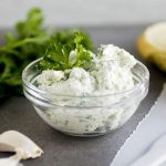 Cream cheese in a small glass bowl.