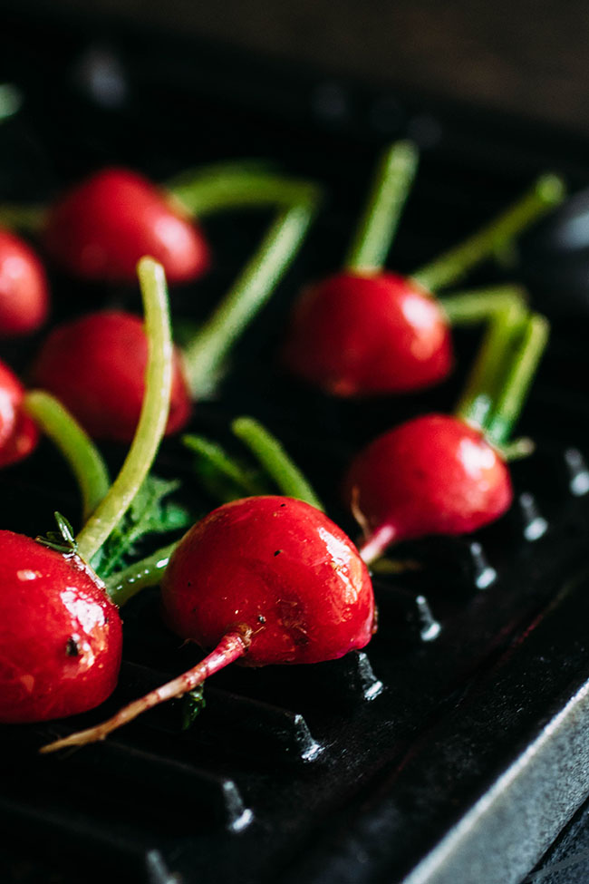 Red radishes on a grill pan.