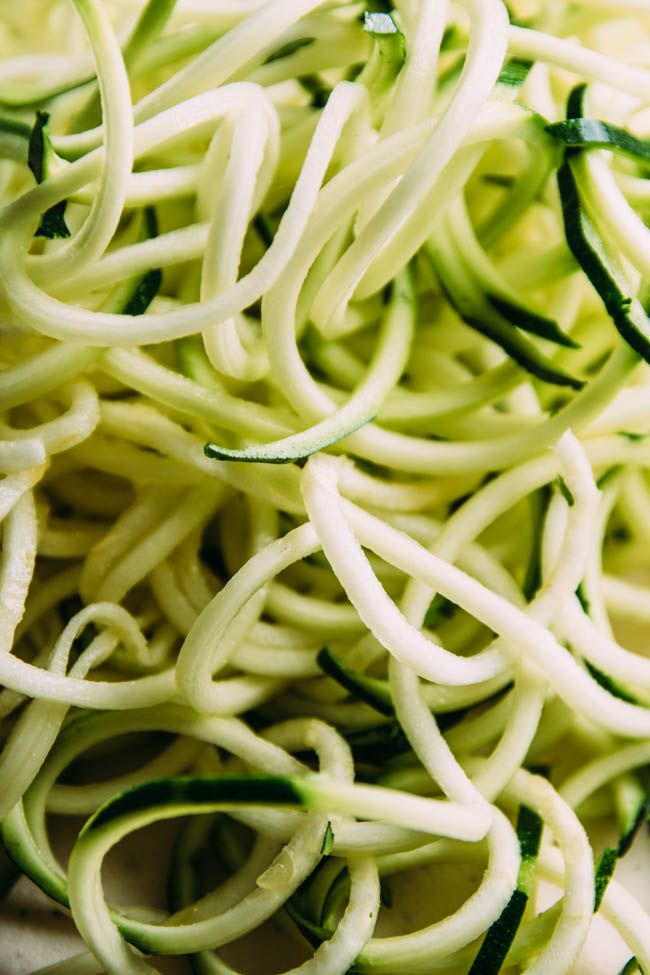 Close up of raw spiralized zucchini noodles.