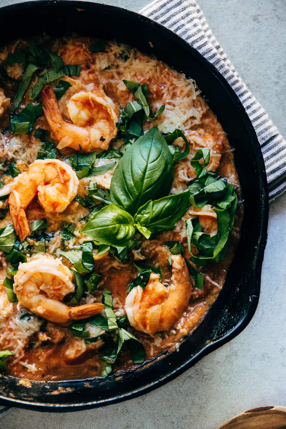 Shrimp and tomato sauce in a large cast iron skillet.