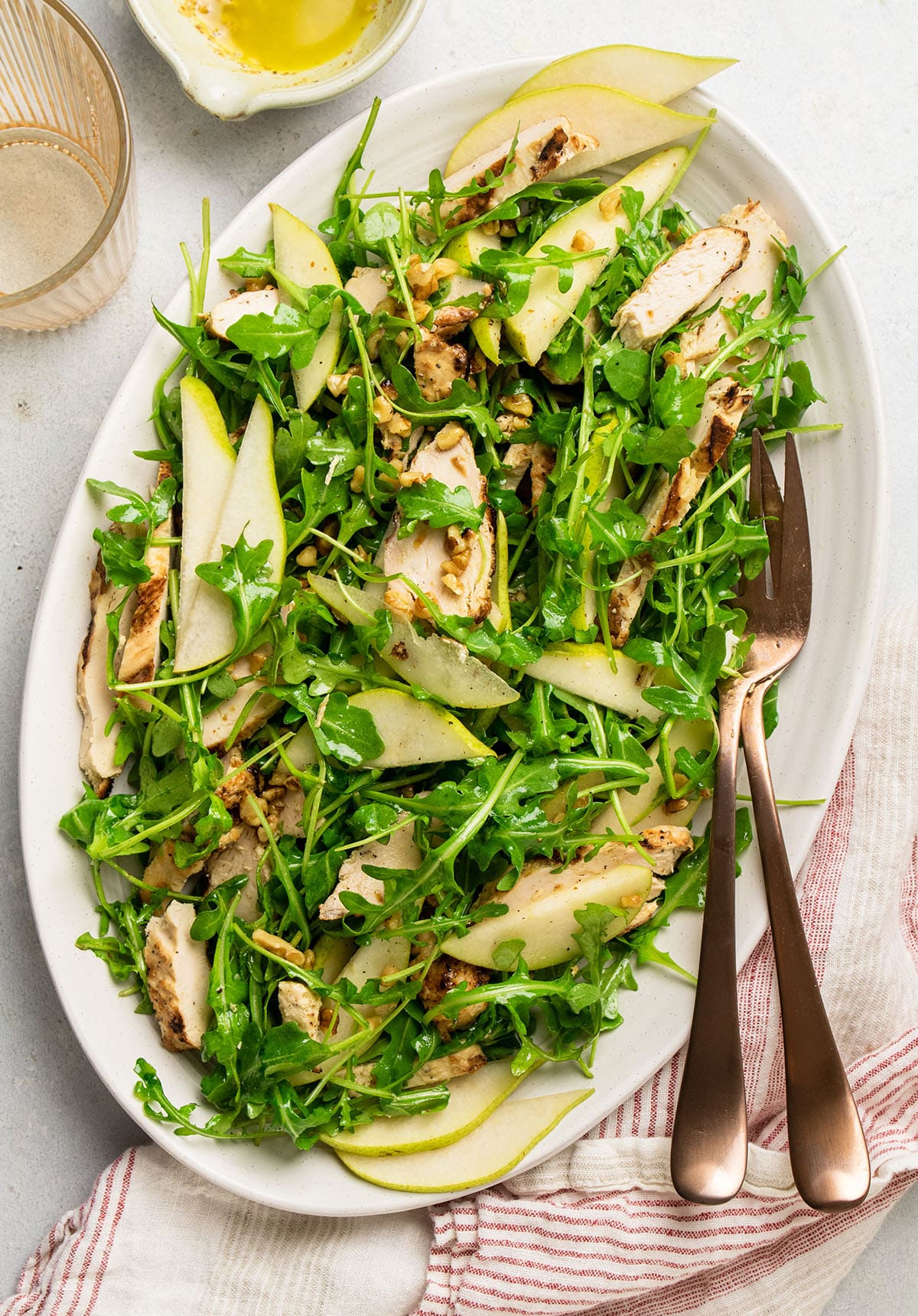 Arugula chicken salad topped with fresh pear slices.