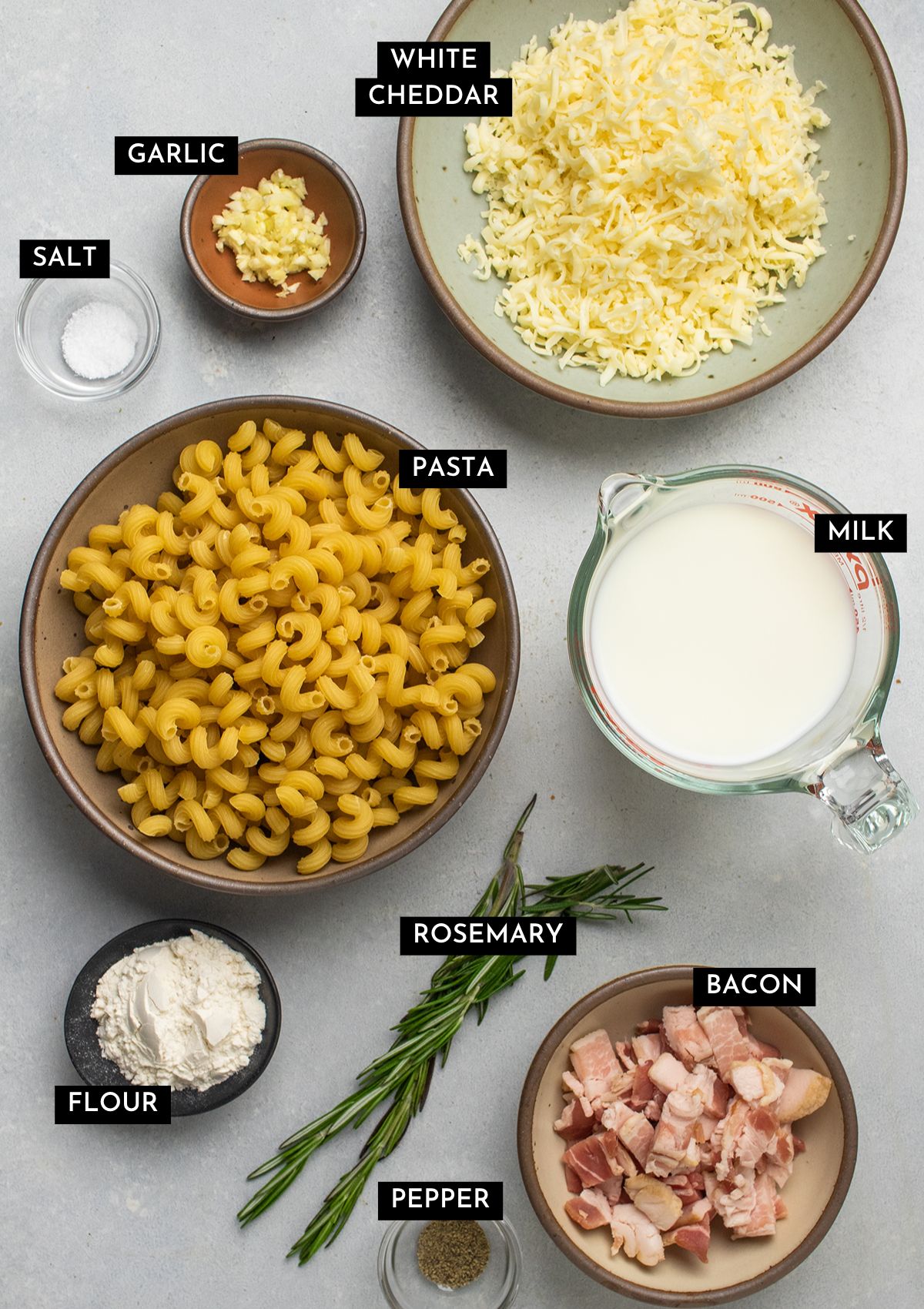Mac and cheese ingredients on a white table.