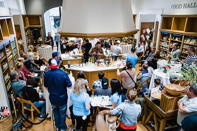 Attendees watch a bartending competition inside the Portland Williams Sonoma.