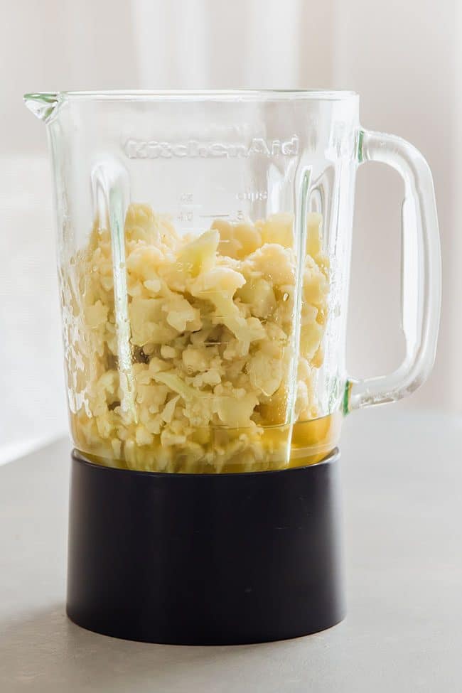 Cauliflower and vegetable stock in a glass blender.