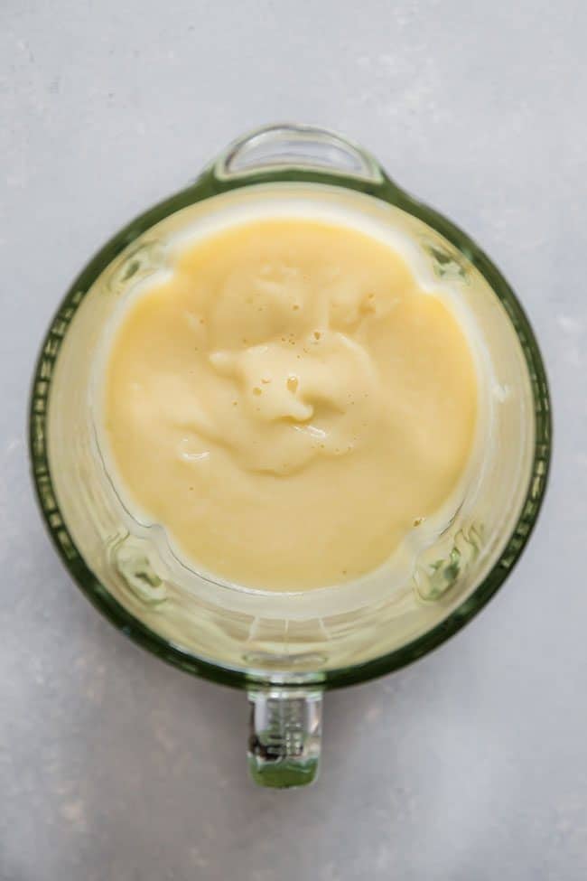 Overhead view of puréed cauliflower in a glass blender. 